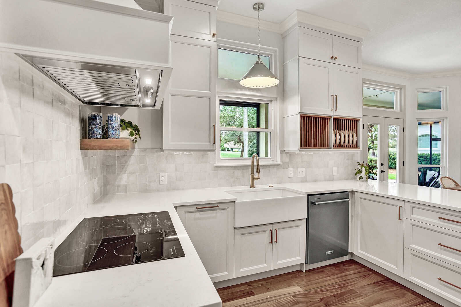 bright transitional kitchen cooktop farmhouse sink view