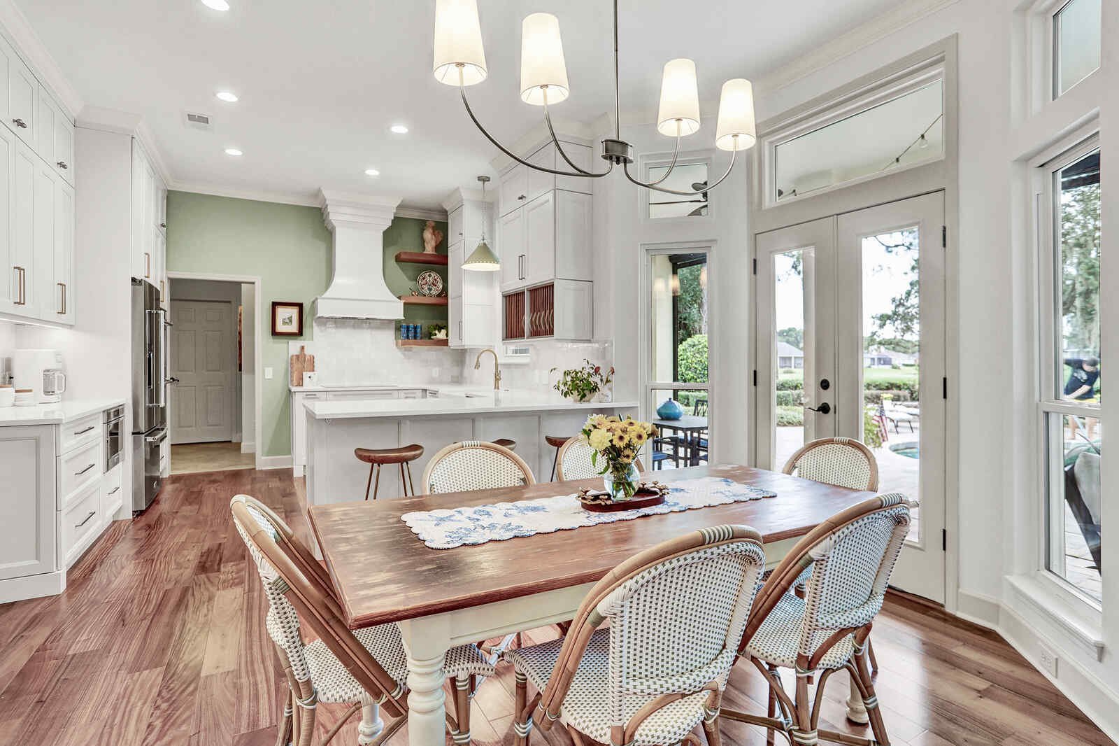 bright transitional kitchen dining area pool doors