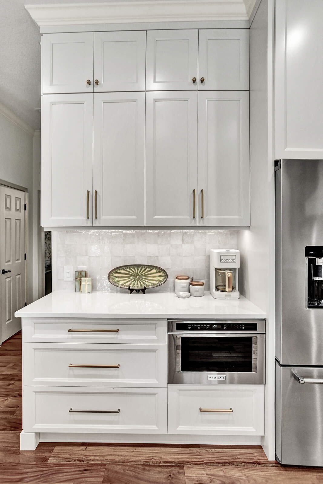 bright transitional kitchen microwave fridge cabinetry