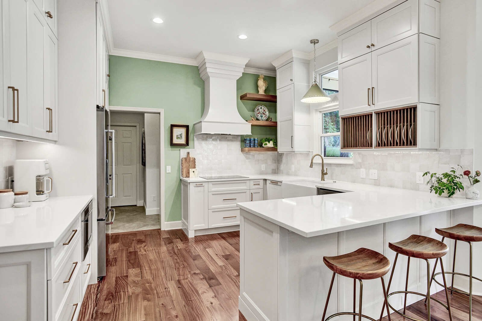bright transitional kitchen range hood green accent wall