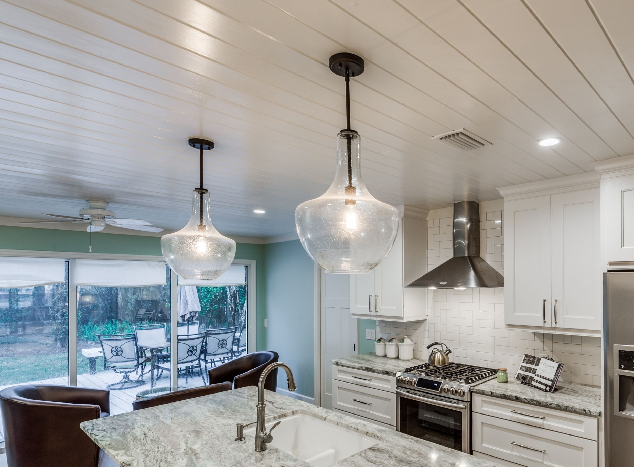 lighting fixtures over kitchen island in a coastal beach renovation