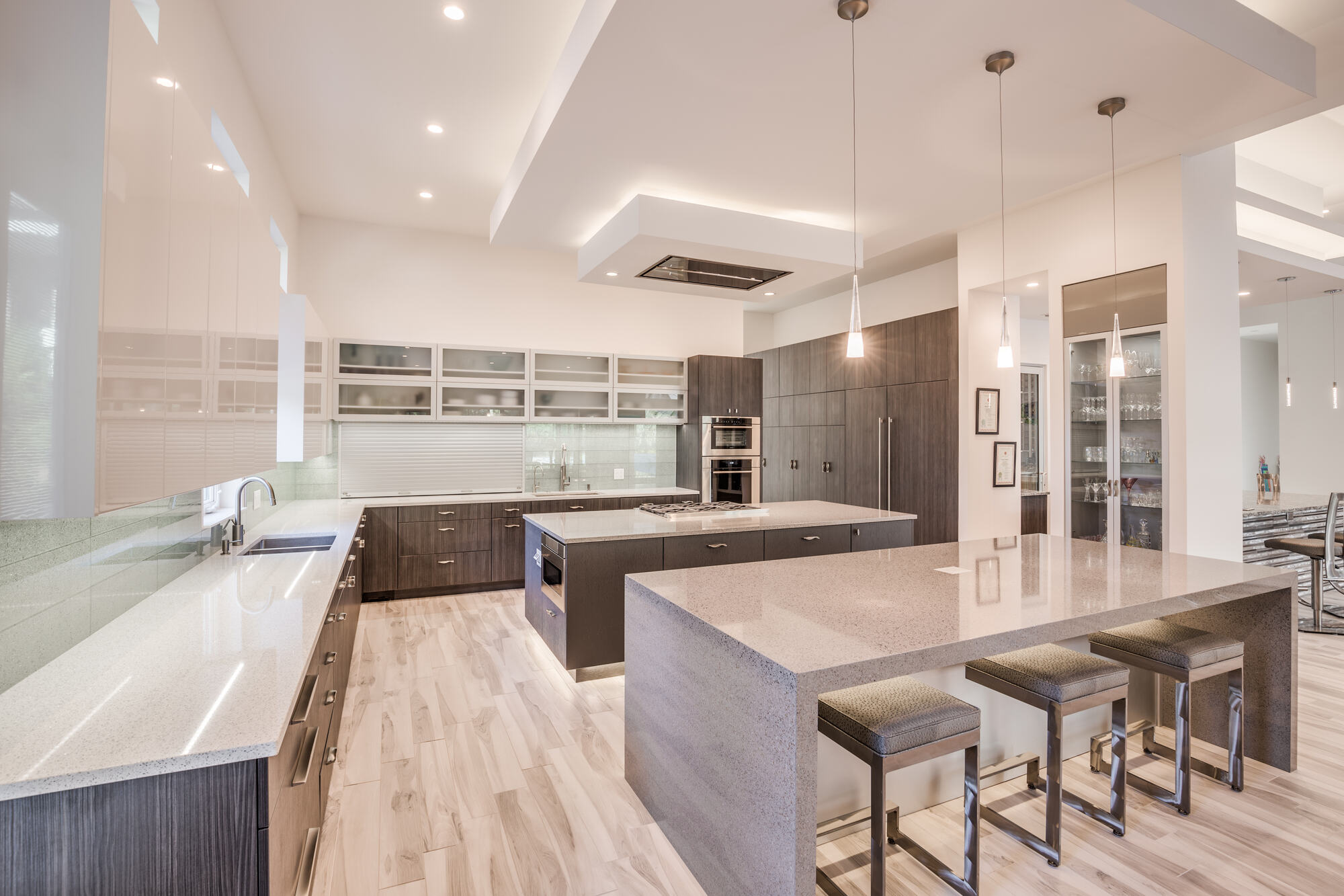 Contemporary kitchen in Jacksonville custom home by BeeTree Homes with sleek cabinetry and island seating