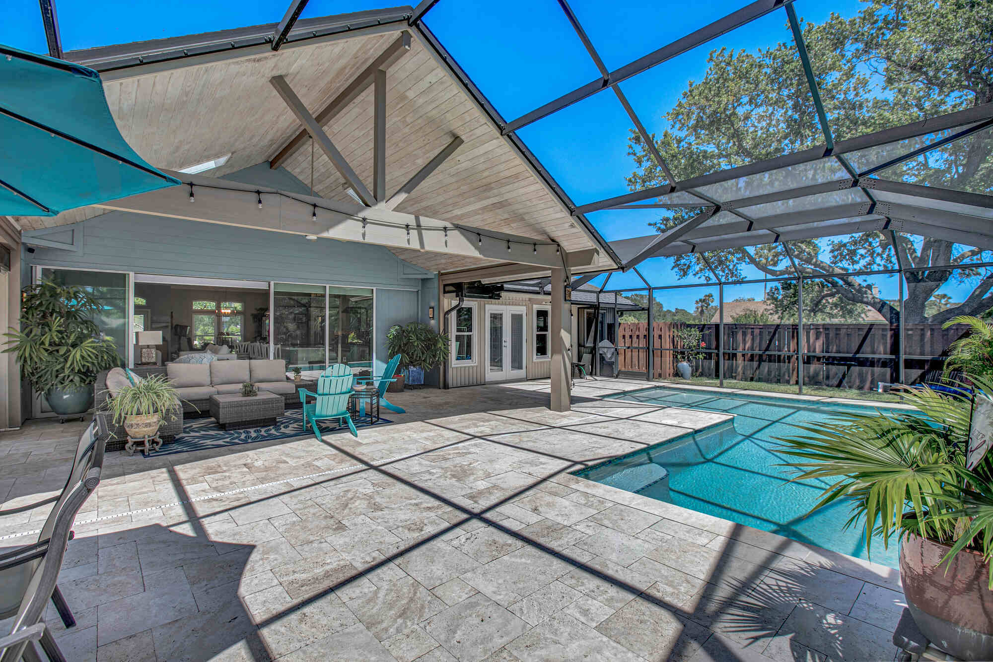 Covered lanai with screened pool enclosure in Jacksonville custom home by BeeTree Homes Covered lanai with screened pool enclosure in Jacksonville custom home by BeeTree Homes