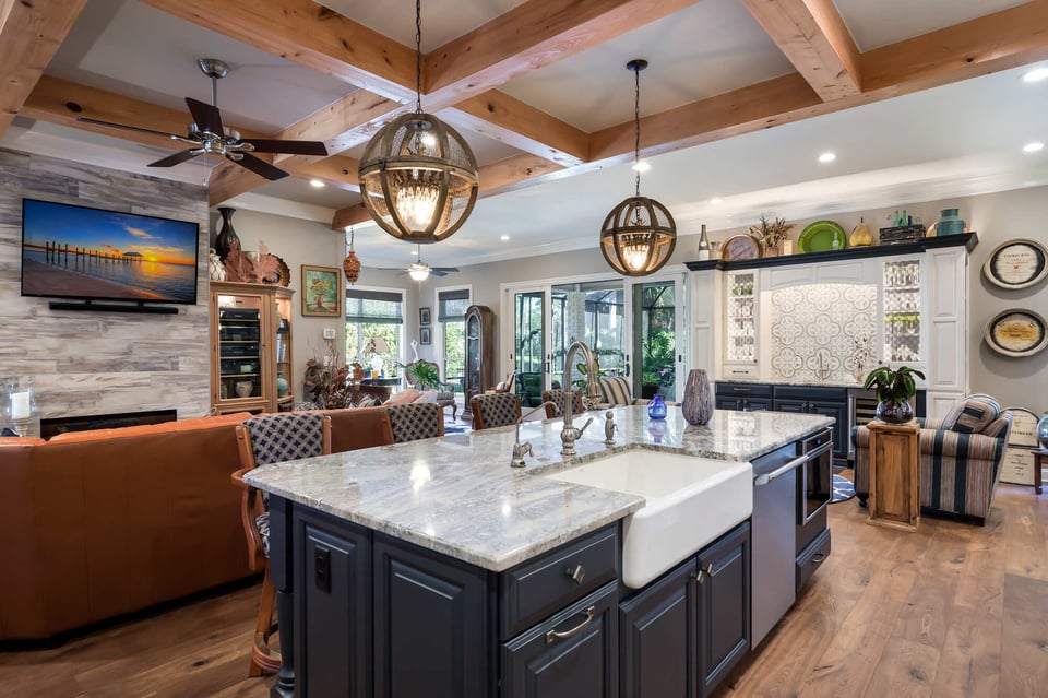 Open concept kitchen and living area with large island by BeeTree Homes in Jacksonville Beach, FL