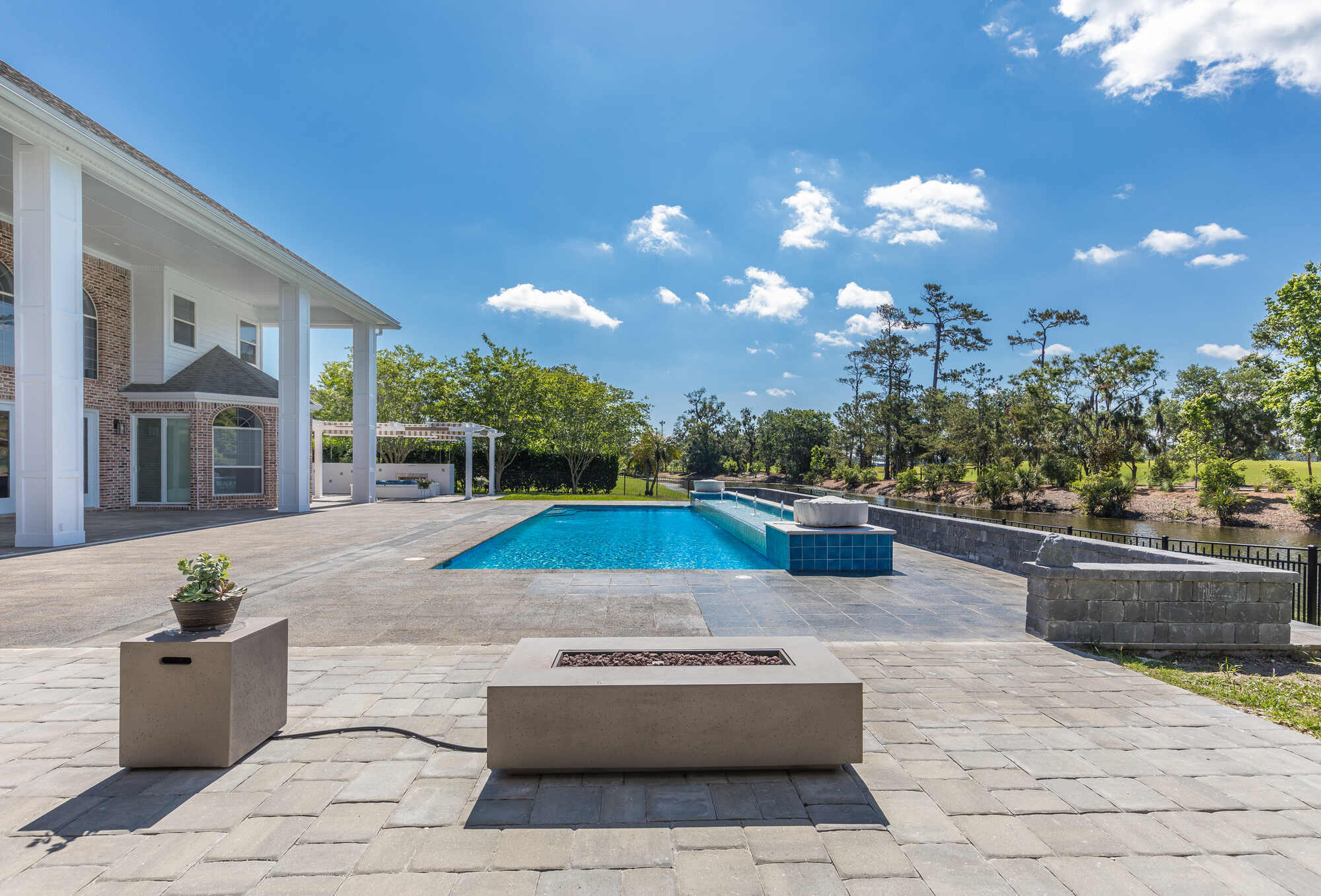 Outdoor living space with large pool at a BeeTree Homes custom build in Jacksonville, FL