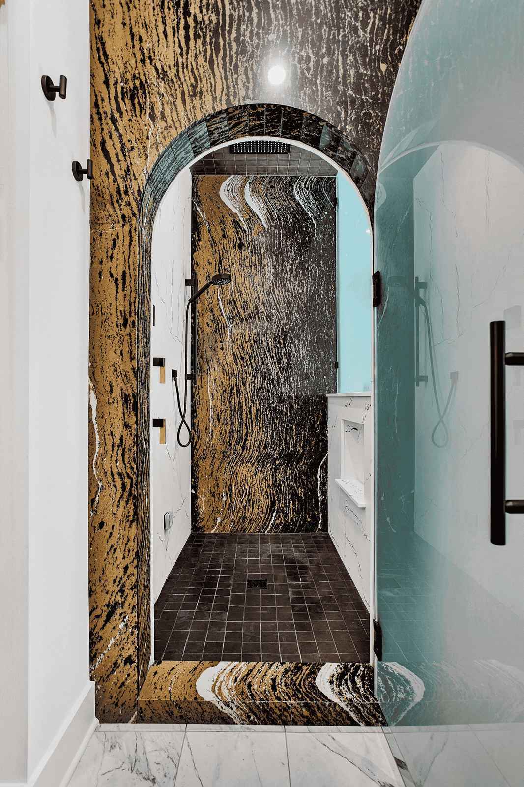 walk in shower with arched frosted glass door in a luxury master bathroom remodel