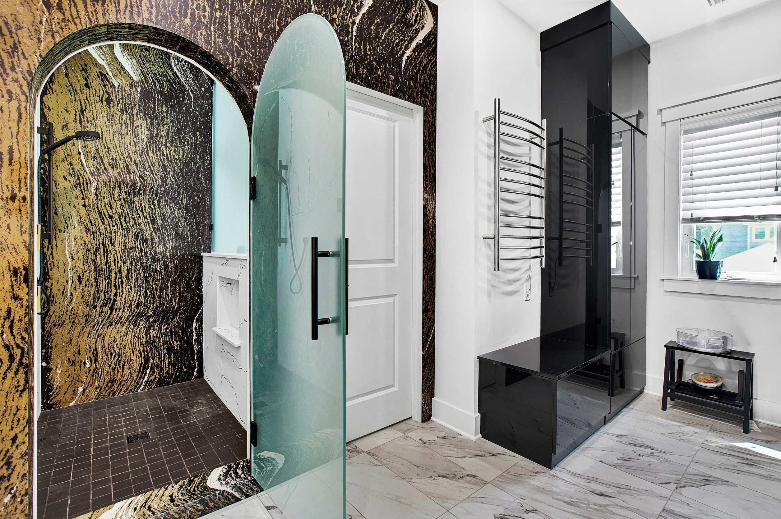 luxury remodel in jacksonville, fl with dark tile and glass door walk in shower