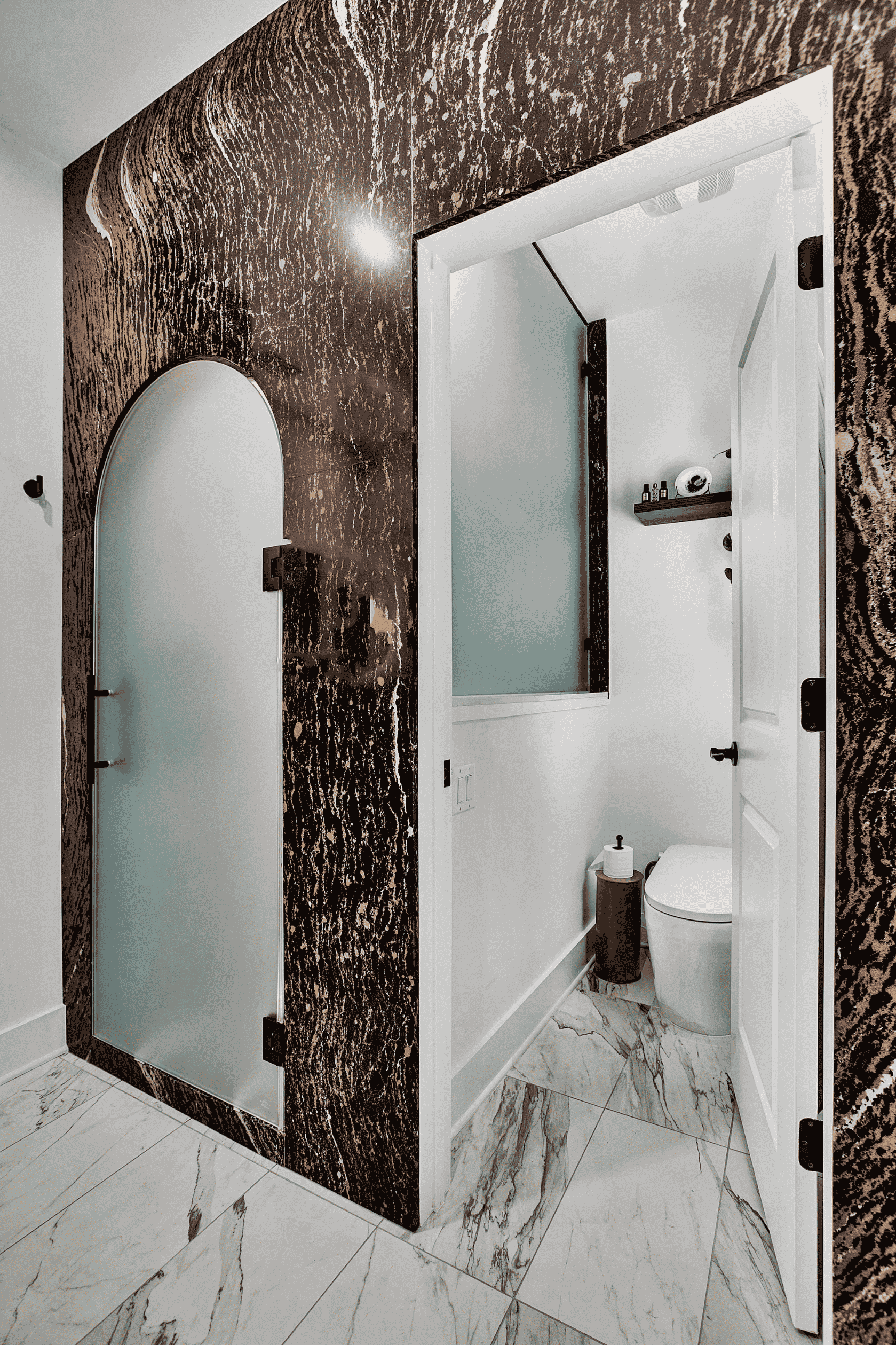 wash closet and frosted glass shower door in a master bathroom remodel