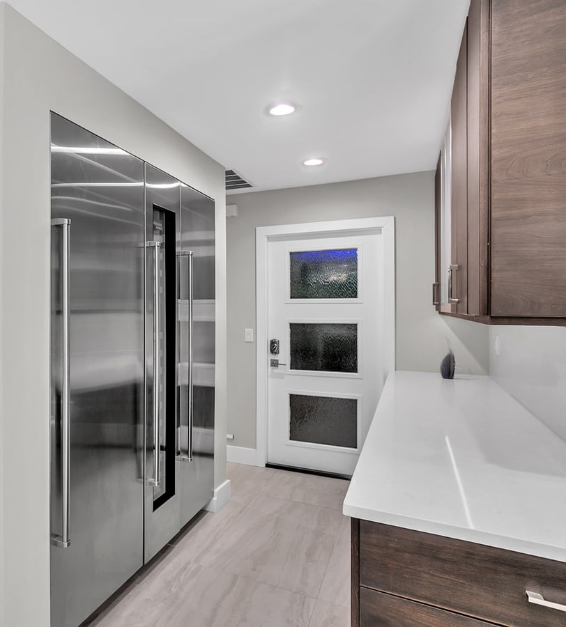 Contemporary kitchen storage and entryway in custom Jacksonville residence by BeeTree Homes