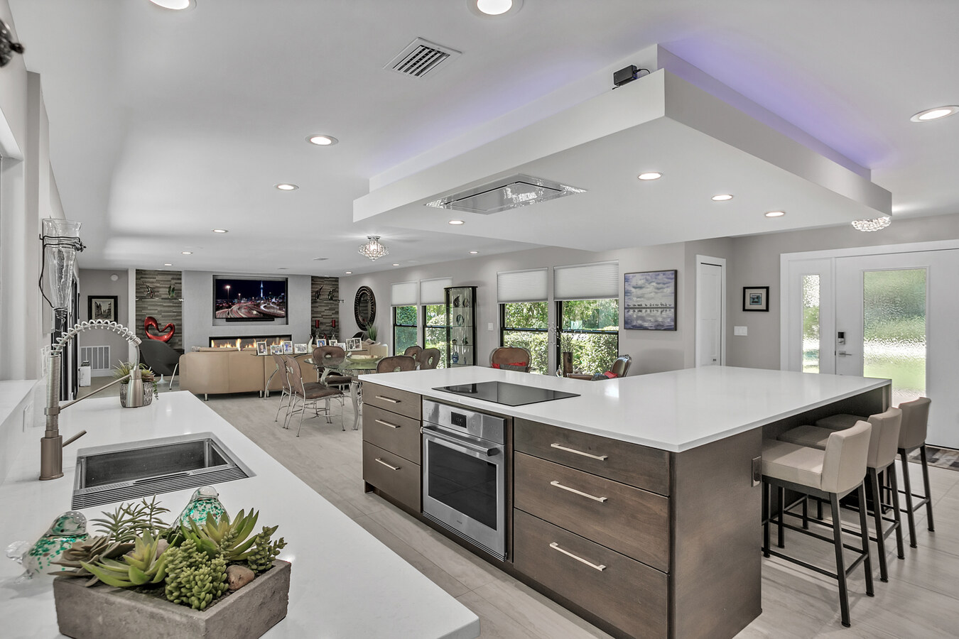 Large kitchen island with integrated cooktop in a Jacksonville custom home by BeeTree Homes