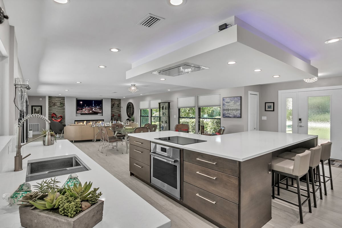 Large kitchen island with integrated cooktop in a Jacksonville custom home by BeeTree Homes
