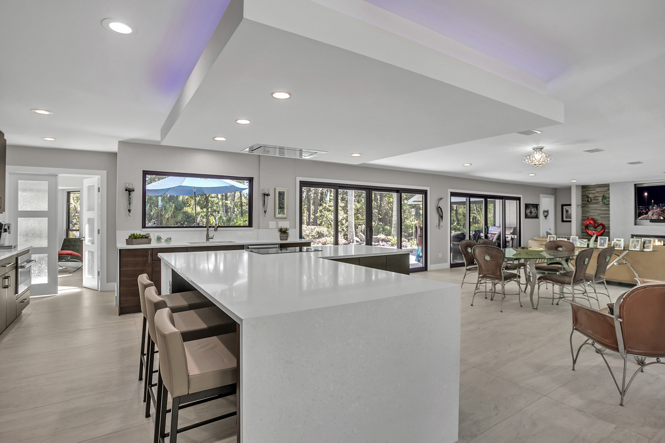 Open kitchen and dining area overlooking backyard in BeeTree Homes custom Jacksonville home