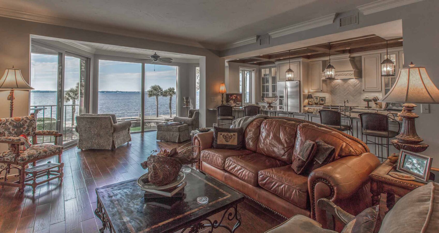 Transitional living and kitchen space featuring leather furniture and oceanfront scenery in Jacksonville