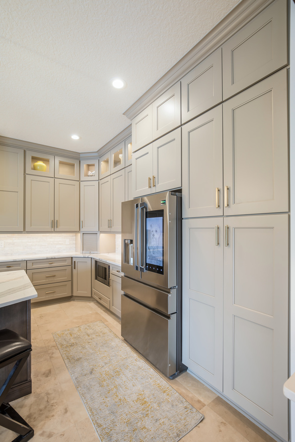 Custom gray and wood-tone kitchen remodel by BeeTree Homes in Jacksonville, FL with marble countertops
