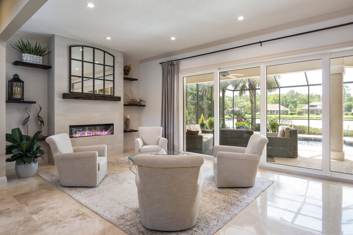 Elegant seating area by BeeTree Homes in Jacksonville Beach, FL with contemporary fireplace design