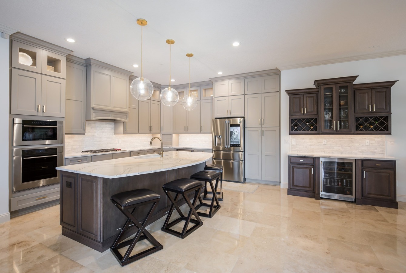 Modern custom kitchen with gray cabinetry and marble island by BeeTree Homes in Jacksonville, FL