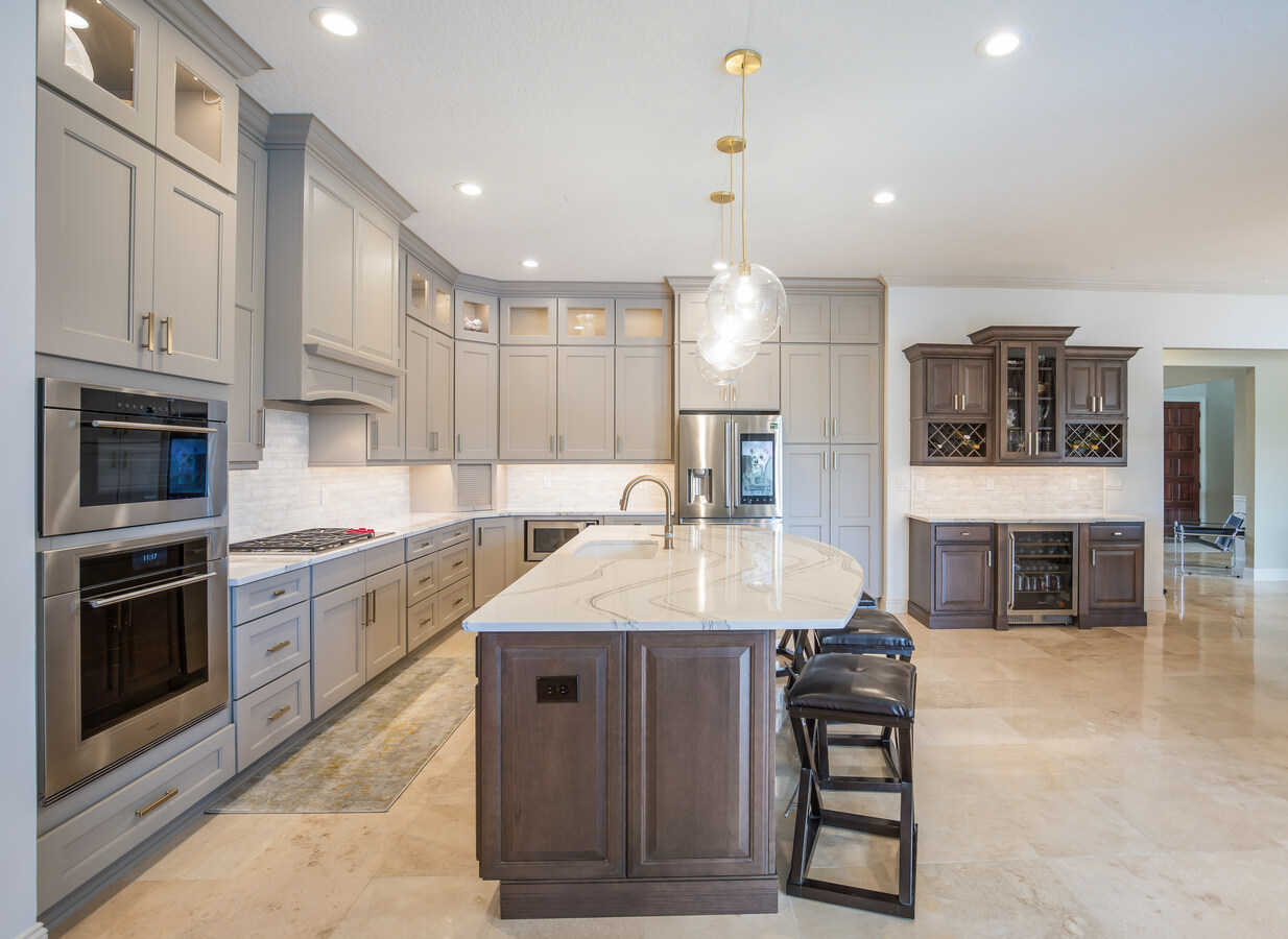 Modern kitchen design in Neptune Beach, FL by BeeTree Homes with high-end appliances and storage solutions