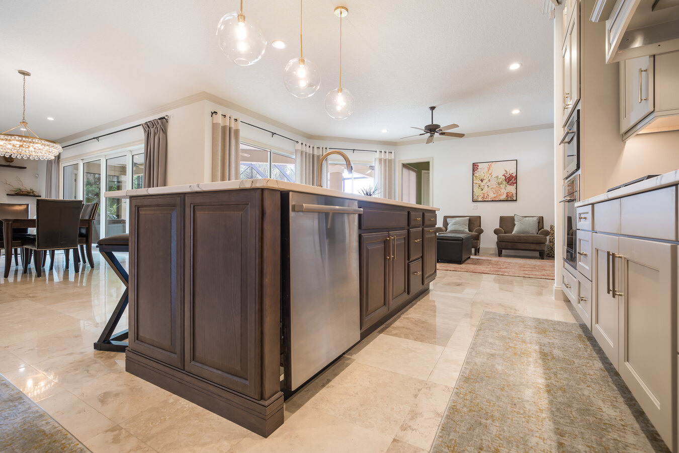 Stylish kitchen remodel by BeeTree Homes in Jacksonville Beach, FL with pendant lighting and bar seating