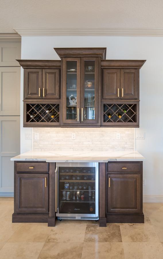 Stylish wet bar and wine storage by BeeTree Homes in Ponte Vedra Beach, FL with dark wood cabinetry