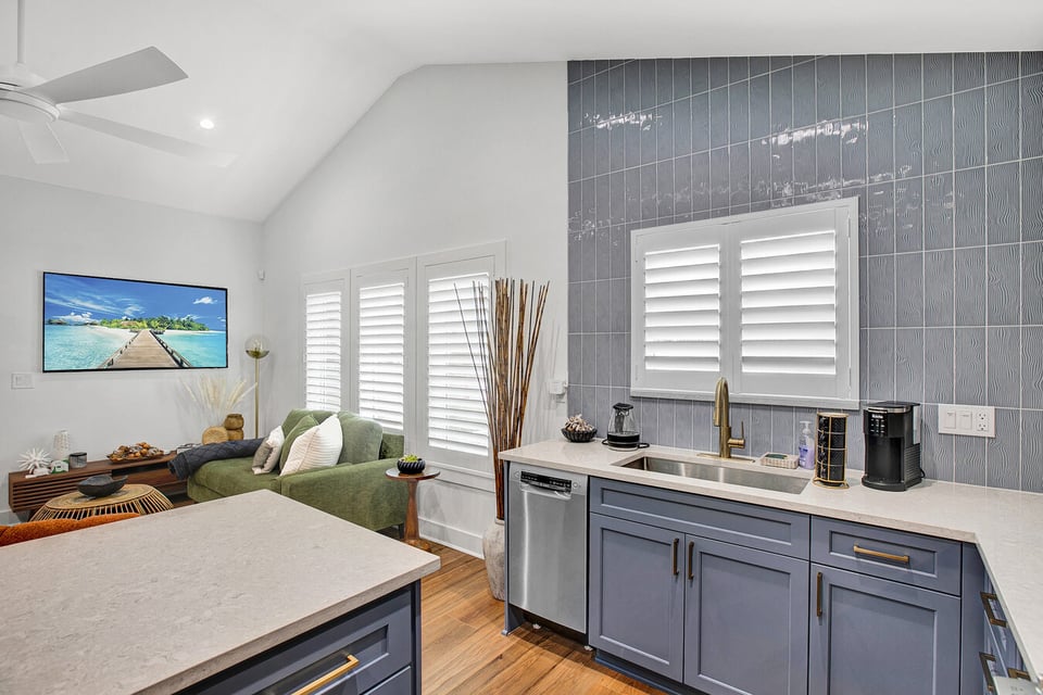 Interior view of kitchen and living space with island seating in custom BeeTree Homes project