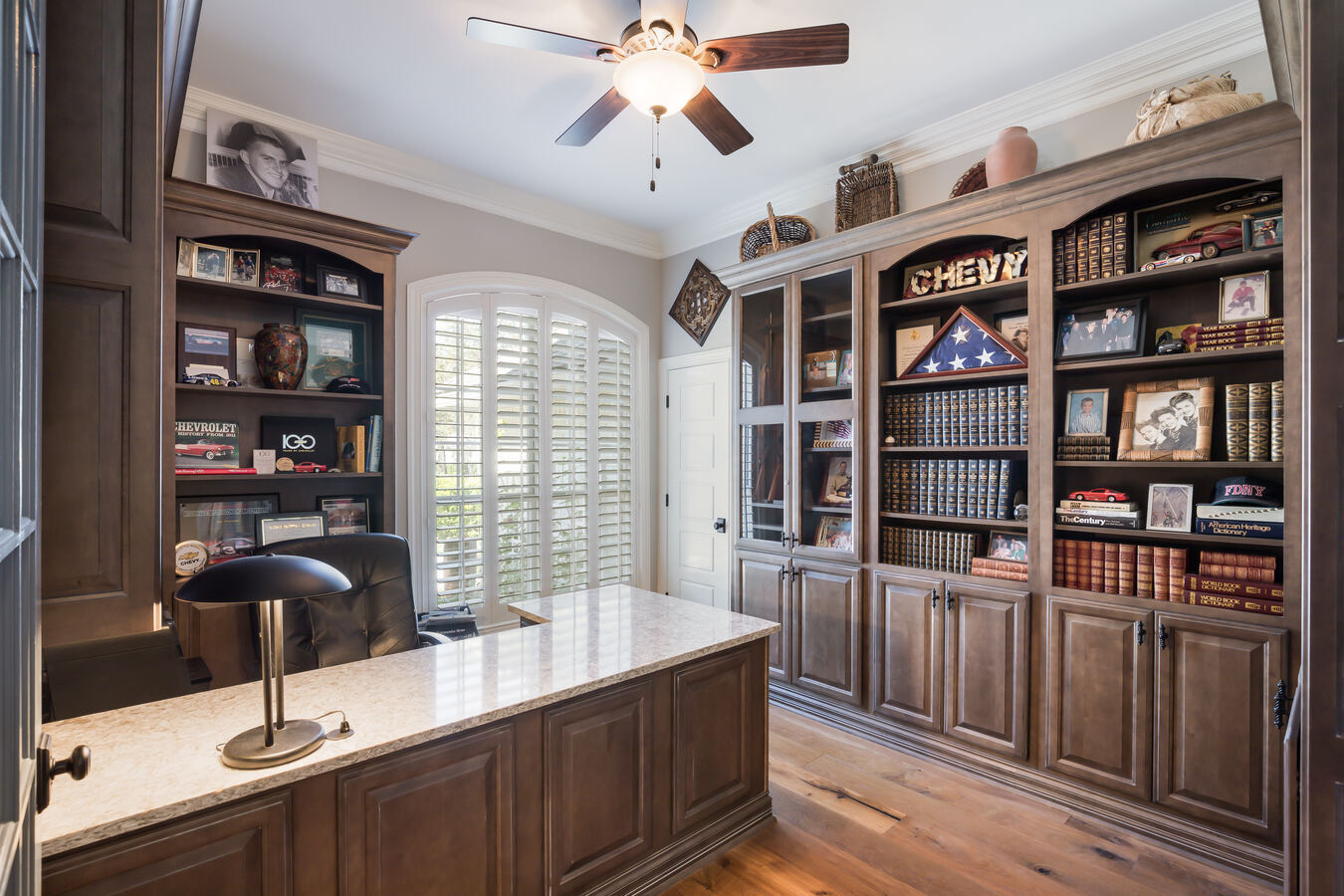 Custom home office with built-in wood shelving in Atlantic Beach, FL by BeeTree Homes