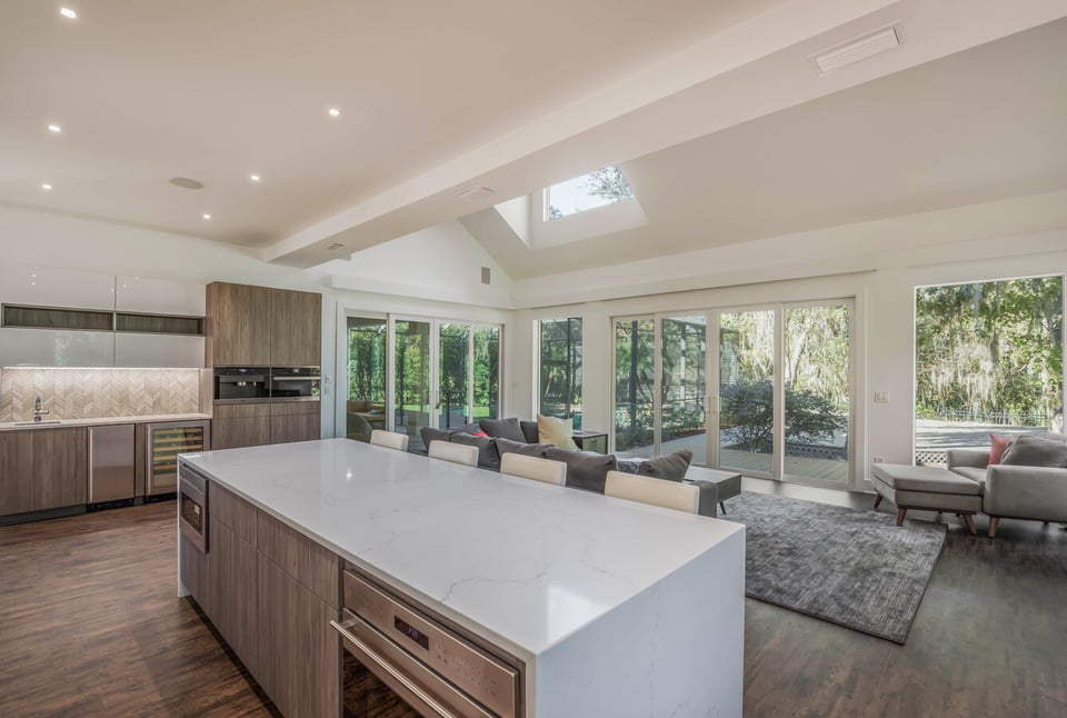 Kitchen and living room with vaulted ceiling in custom BeeTree Homes home, Atlantic Beach, FL