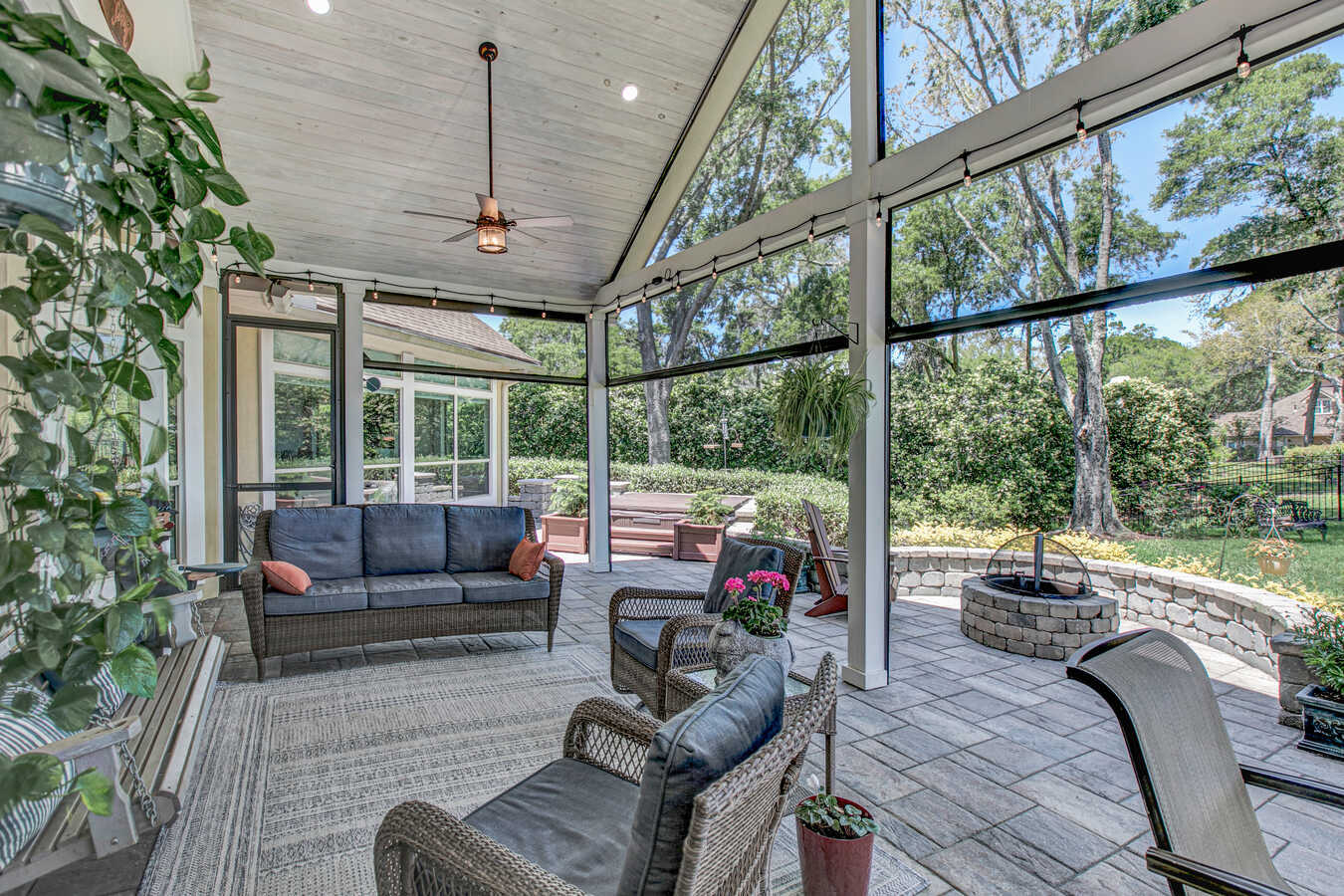Outdoor living space with vaulted ceiling and fan by BeeTree Homes in Jacksonville custom build