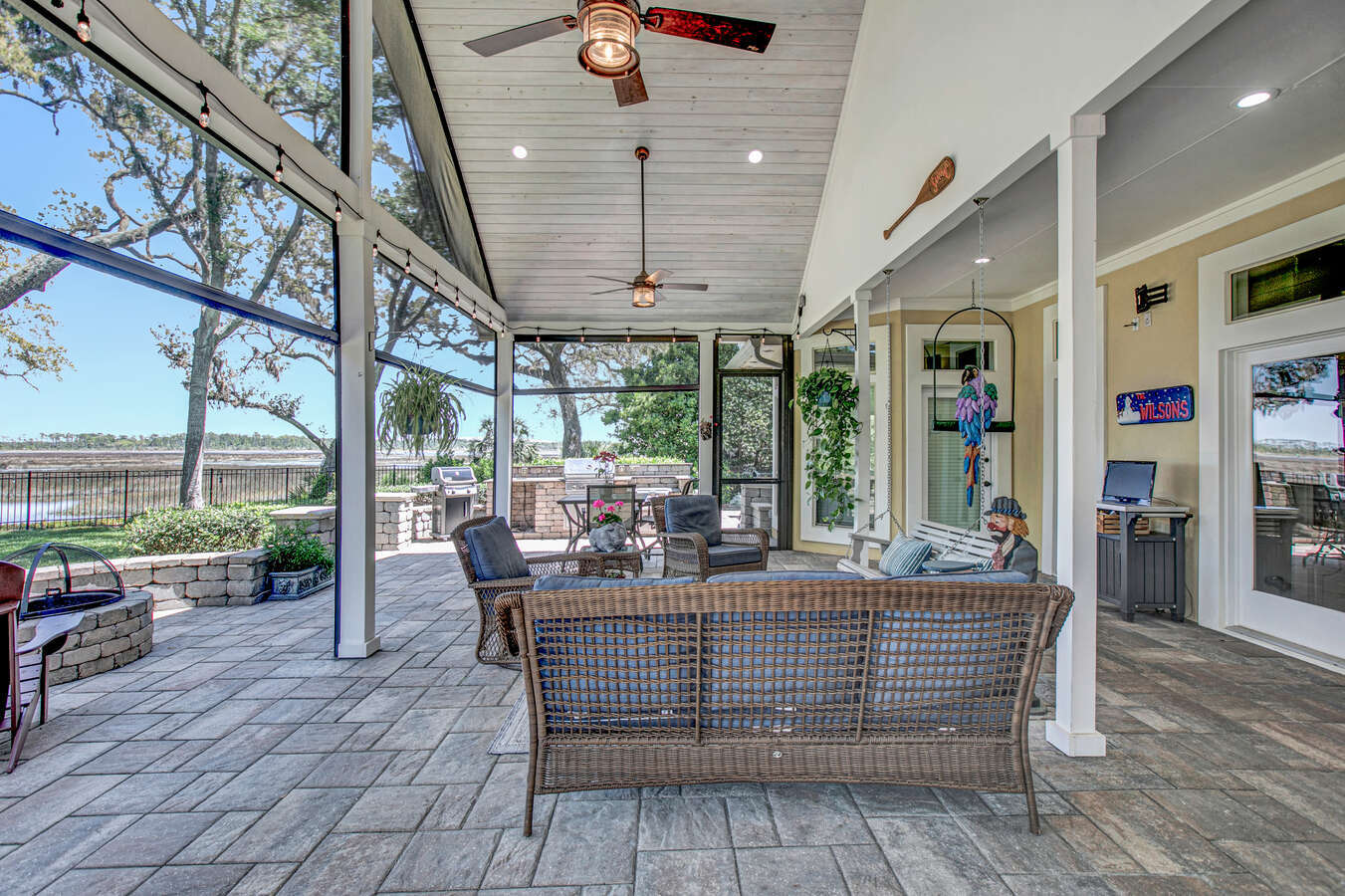 Spacious screened-in outdoor lounge in Jacksonville custom home by BeeTree Homes