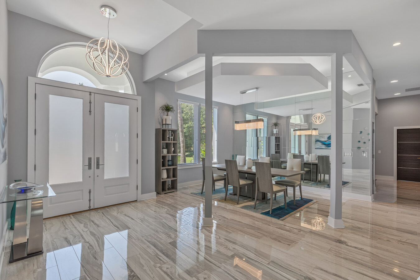 Modern foyer and dining area with architectural ceiling by BeeTree Homes in Jacksonville, FL