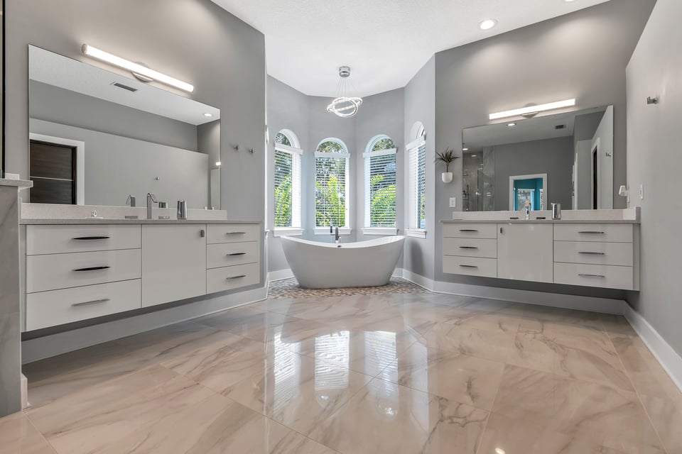 Spa-inspired custom bathroom featuring floating vanities and elegant lighting by BeeTree Homes