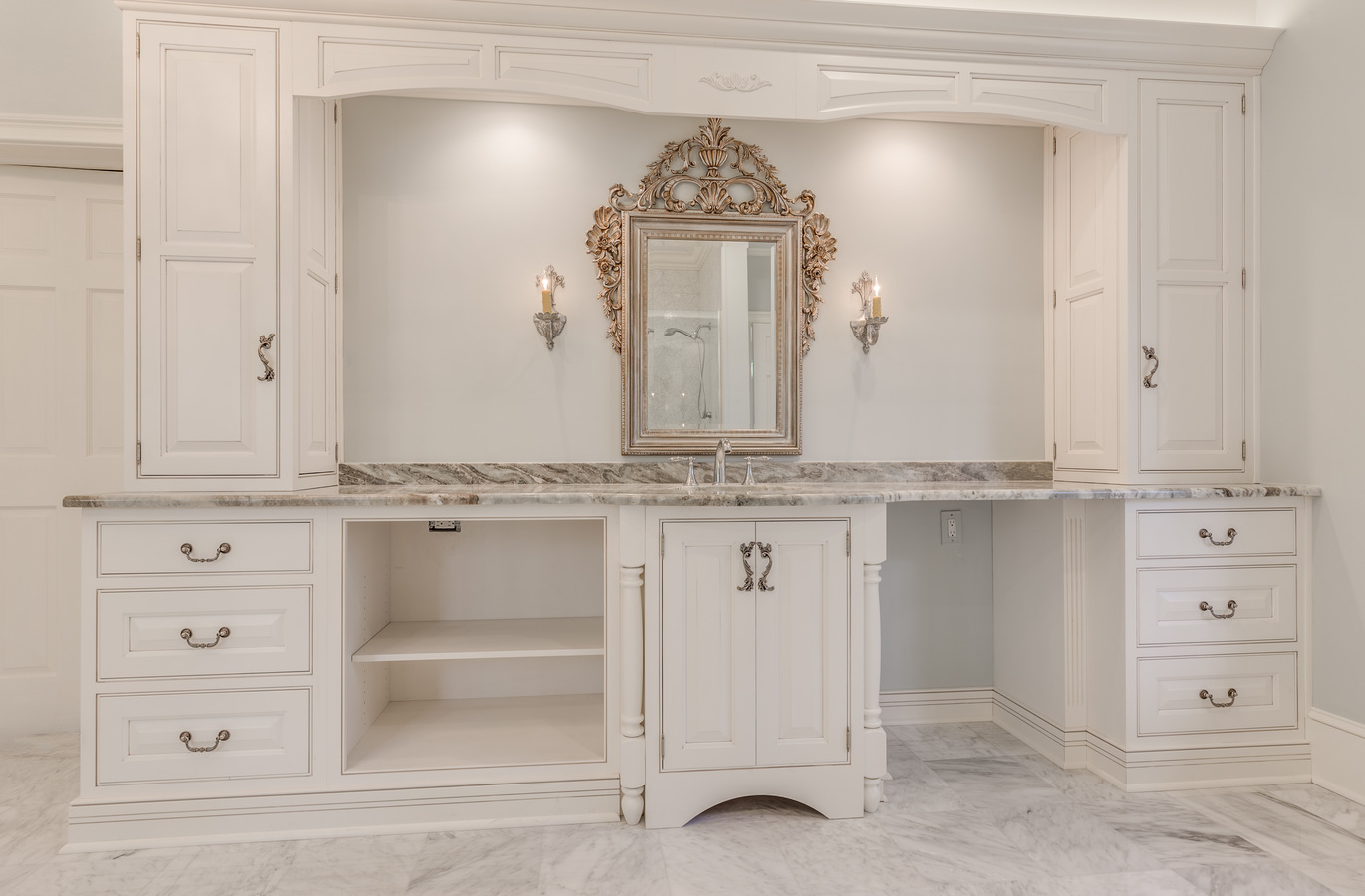 Refined vanity setup with symmetrical cabinets and vintage mirror by BeeTree Homes in Jacksonville FL