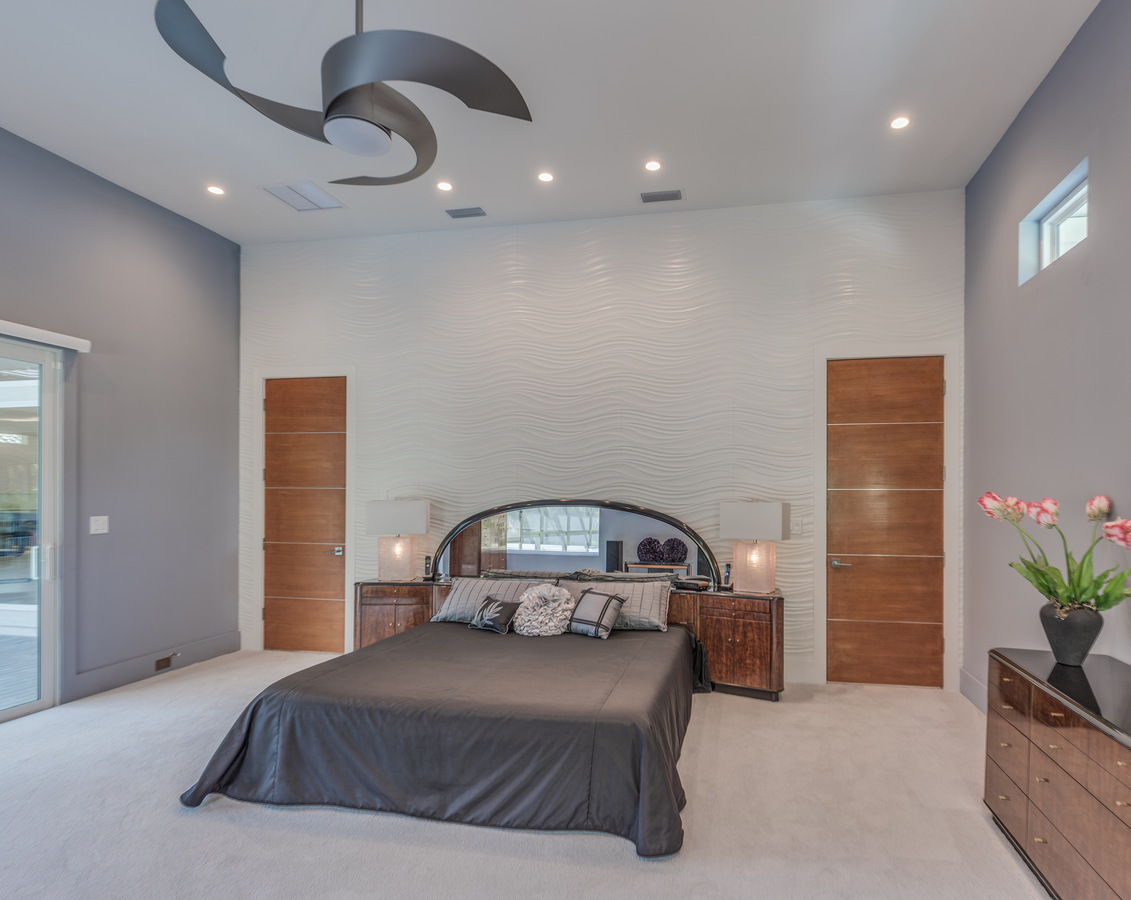 Custom master bedroom with modern ceiling fan in a BeeTree Homes custom home in Jacksonville, FL