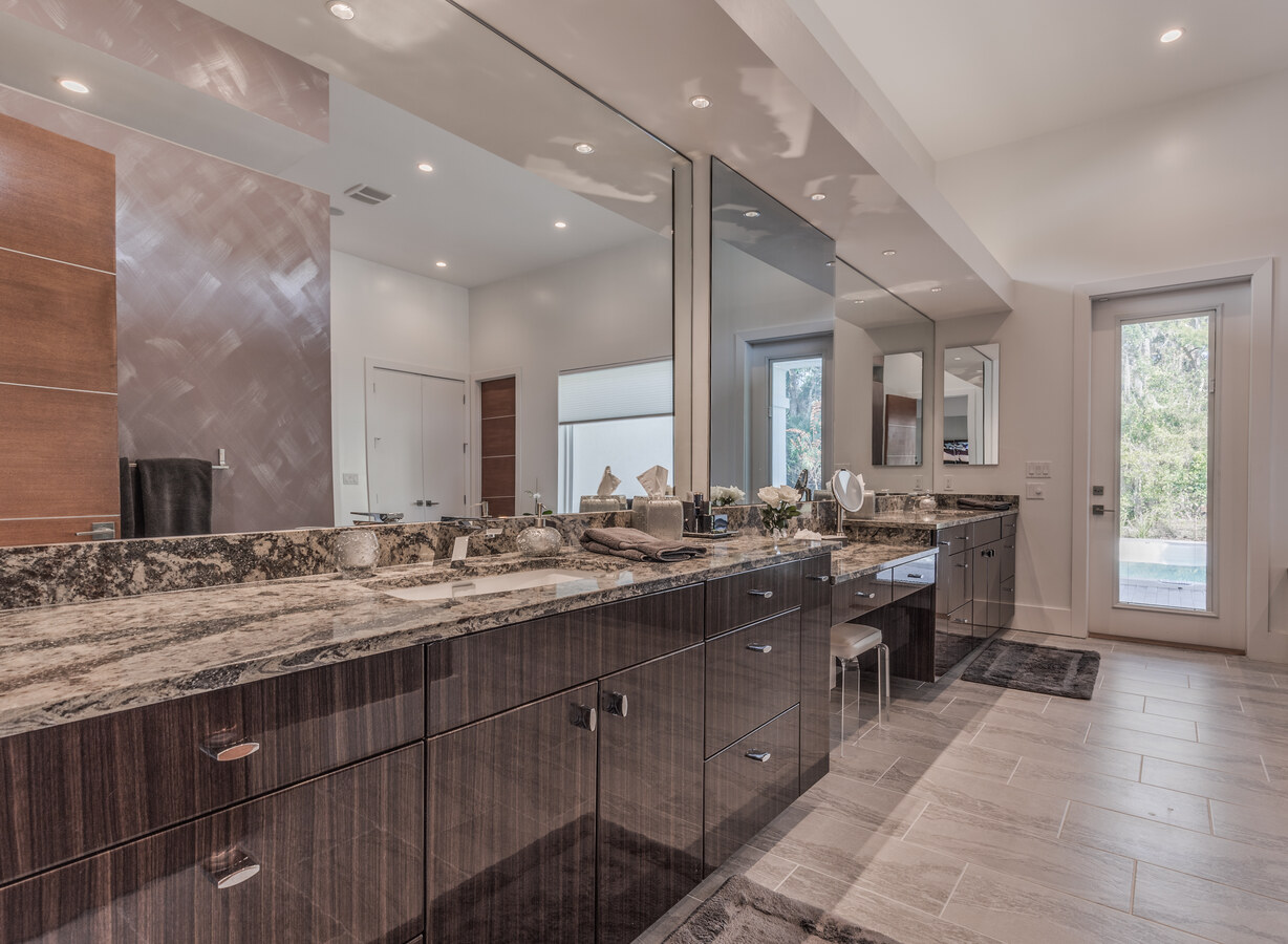 Elegant master bath with full wall mirrors in Jacksonville, FL custom home by BeeTree Homes