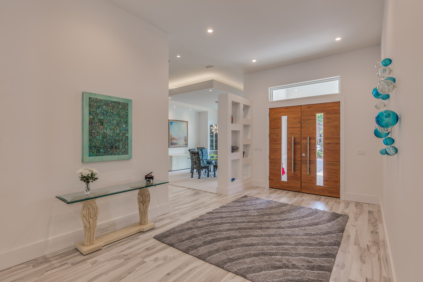 Grand entrance foyer with wood double doors in BeeTree Homes’ Jacksonville custom home