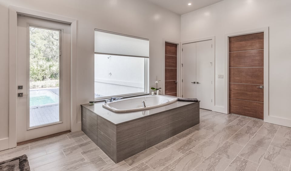Minimalist bathroom with center tub in Jacksonville, FL custom home by BeeTree Homes
