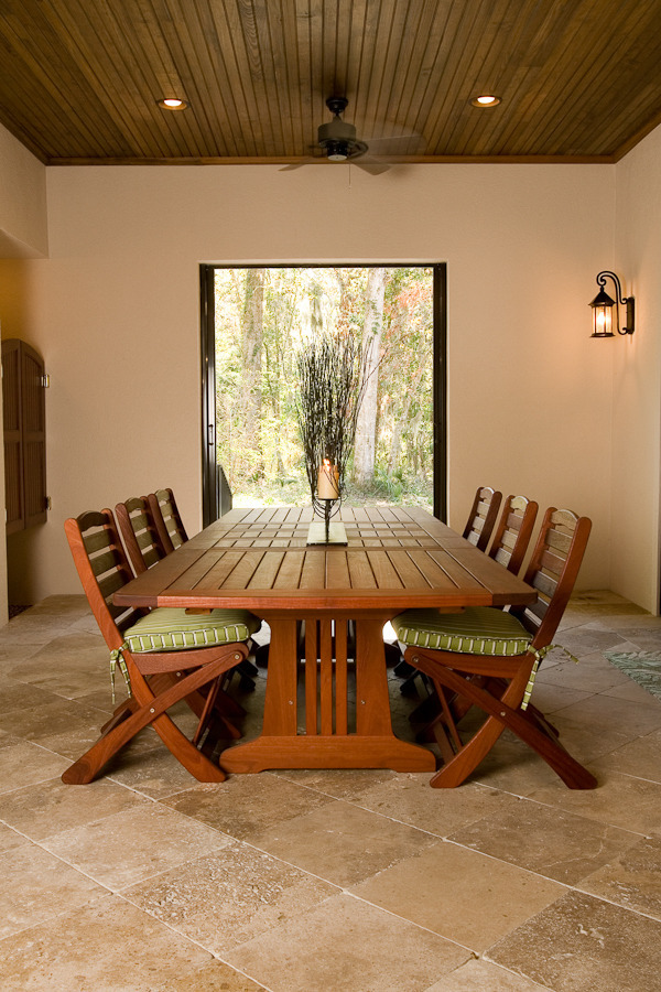 Covered outdoor dining area with wood ceiling in a BeeTree Homes custom home in Jacksonville, FL