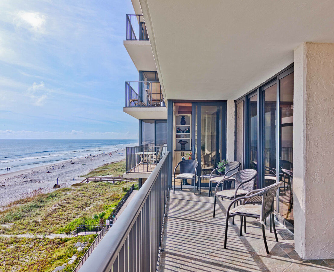 Coastal balcony with beach views and outdoor seating by BeeTree Homes in Jacksonville, FL