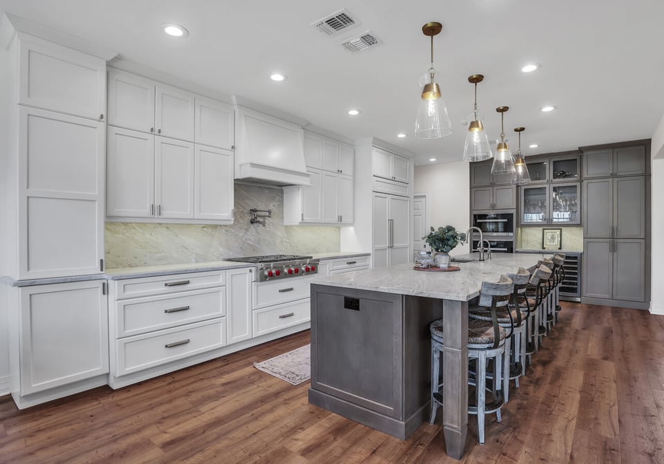 Custom kitchen remodel in Jacksonville, FL with white cabinetry and gray island by BeeTree Homes