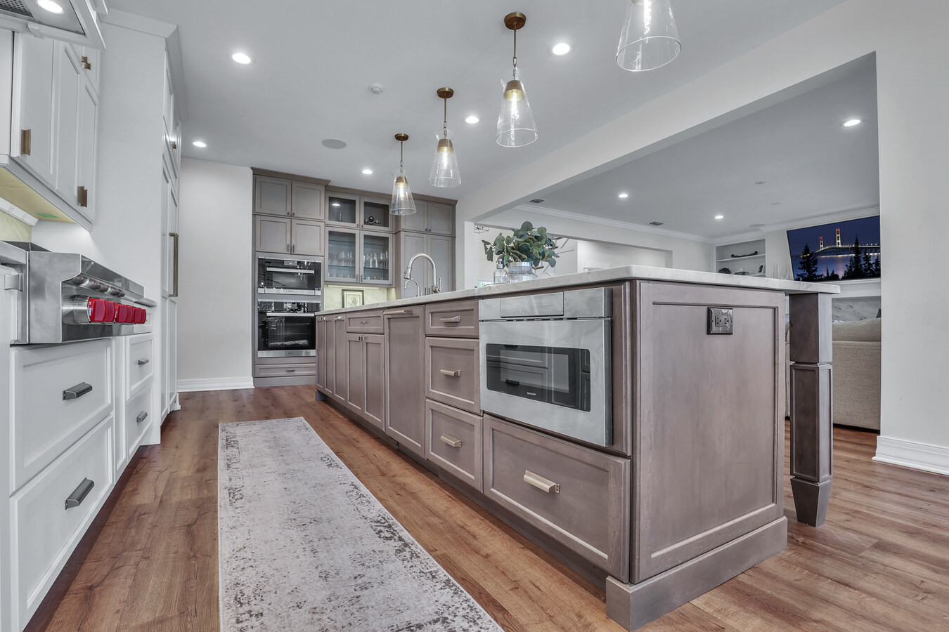 Jacksonville custom kitchen island with built-in microwave and shaker drawers by BeeTree Homes