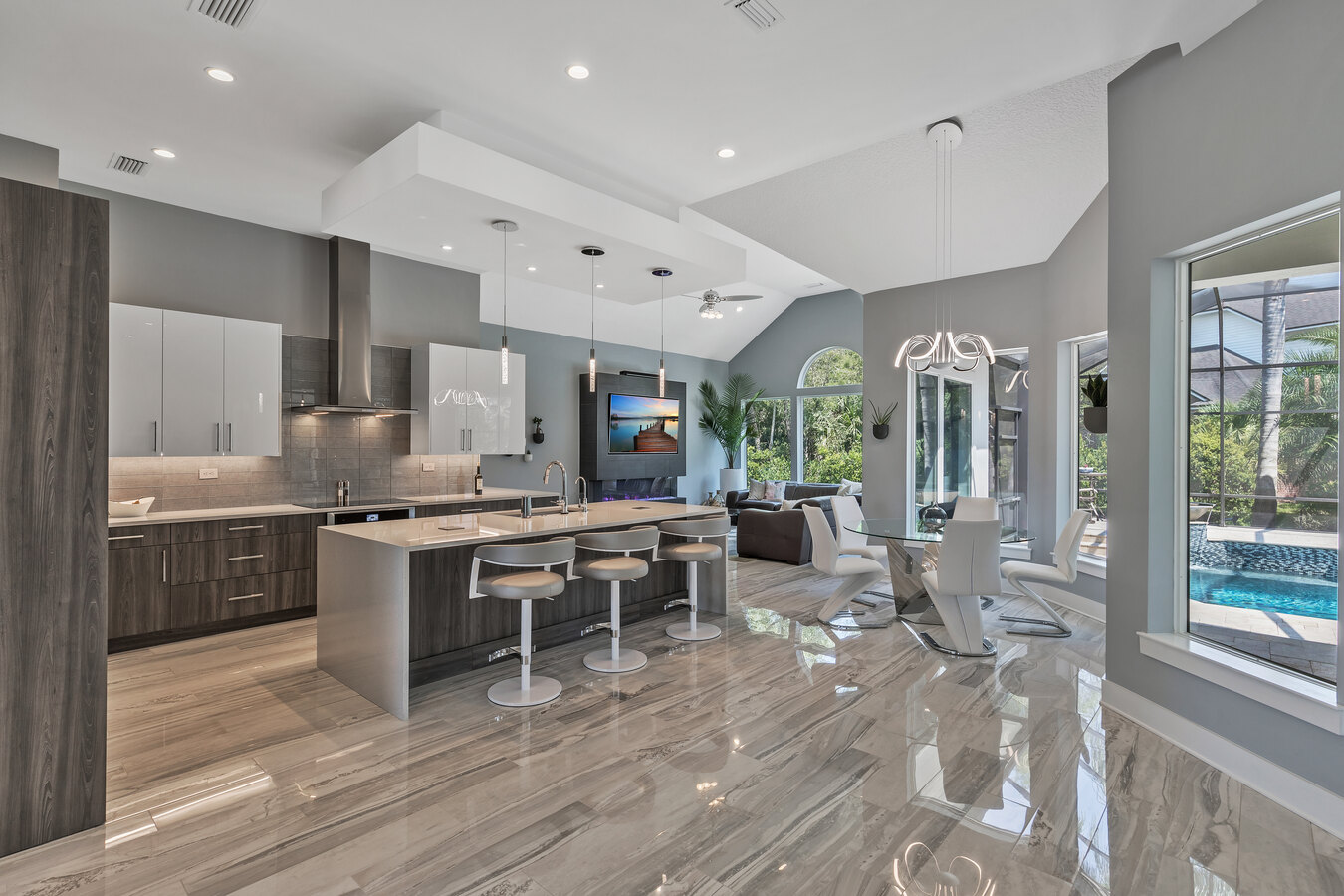 Sleek modern kitchen with high-gloss cabinetry and luxury finishes by BeeTree Homes in Jacksonville, FL