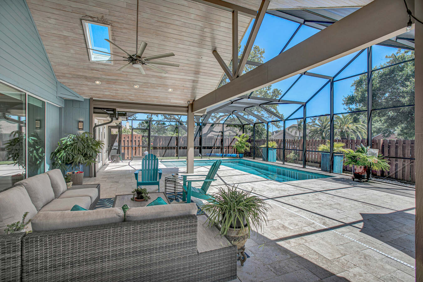 Bright and breezy covered pool area with tile flooring and vaulted ceiling by BeeTree Homes, Jacksonville, FL