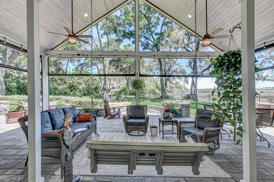 Outdoor living space with porch swing and wicker seating built by BeeTree Homes in Jacksonville, FL