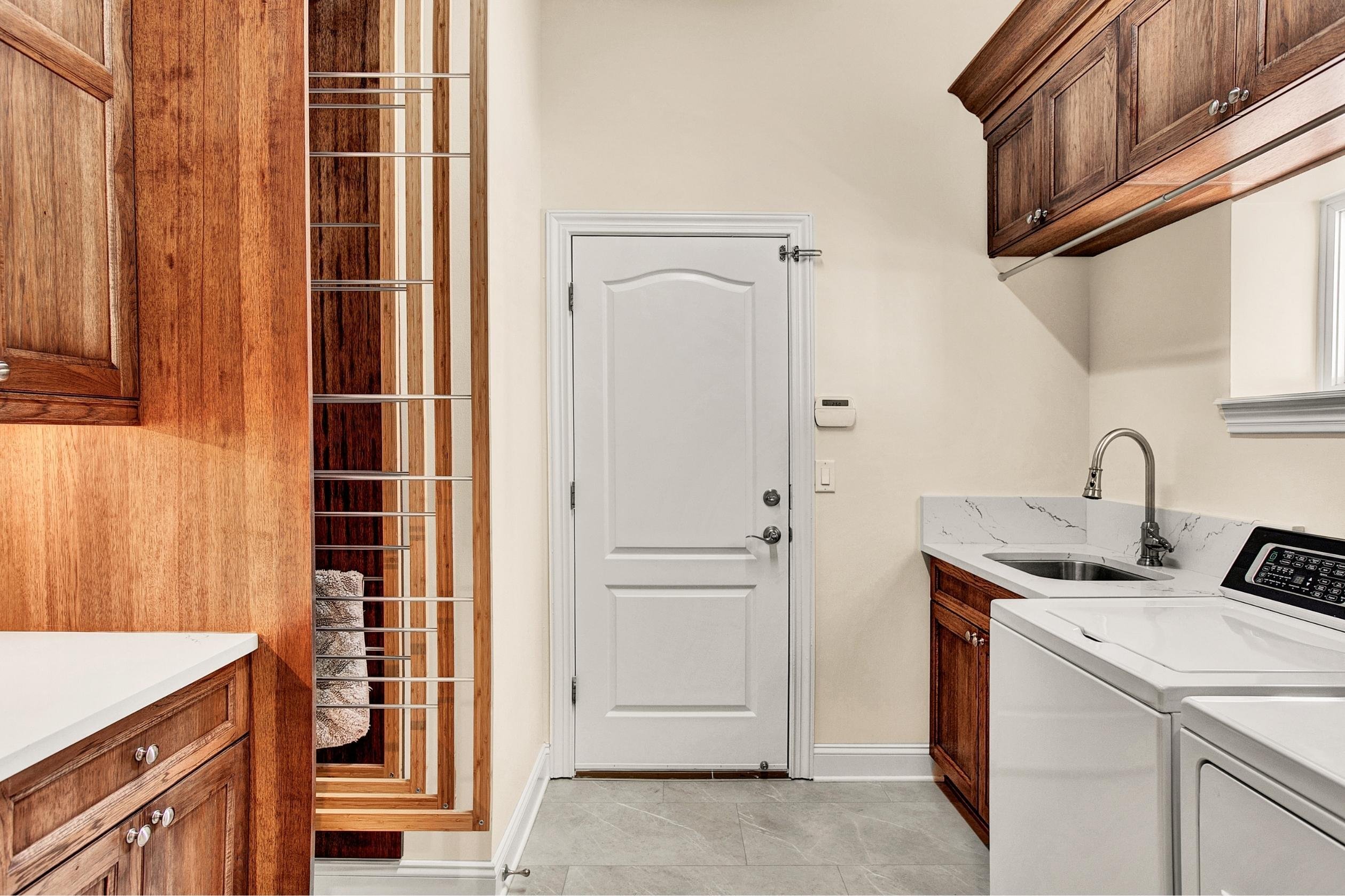laundry room with wood cabinets and drying racks in jacksonville home remodel