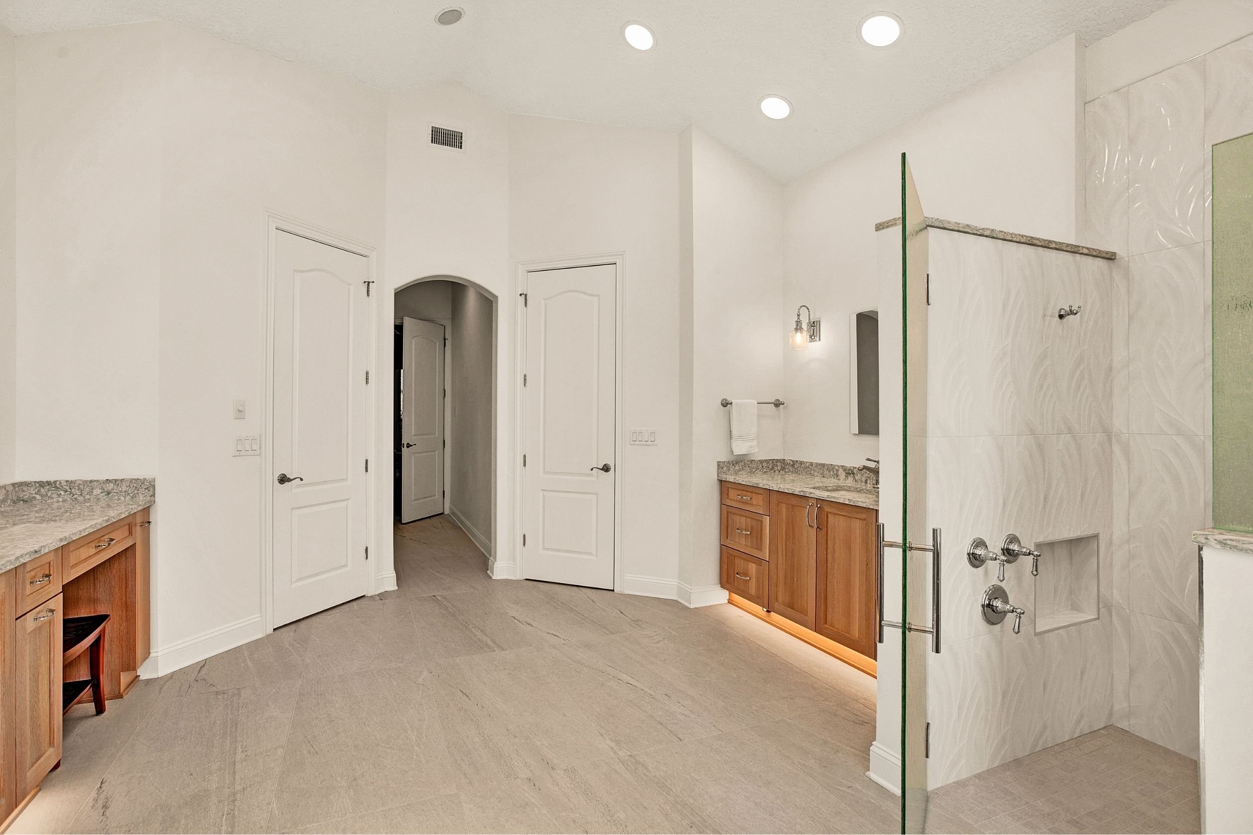 primary bathroom remodel in jacksonville with walk in shower and arched doorway