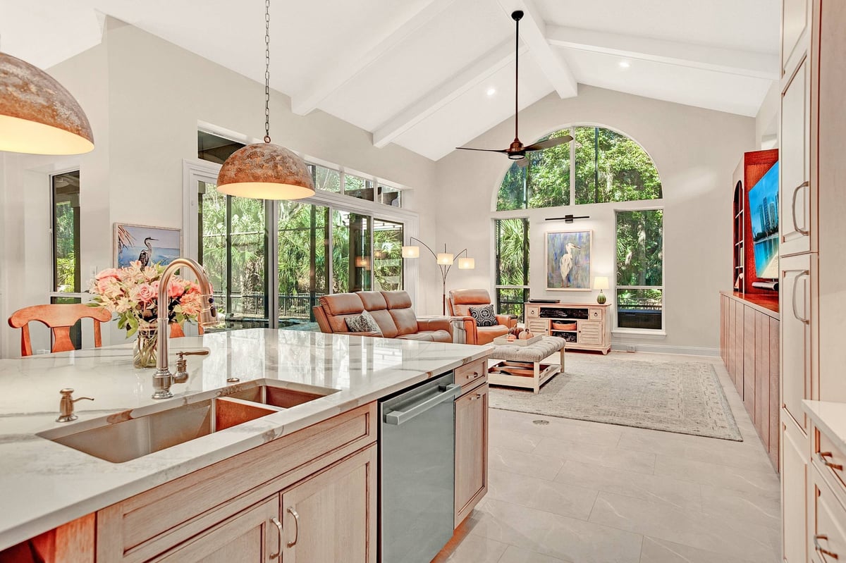 warm neutral open concept kitchen and living room remodel with caulted ceilings in jacksonville, fl