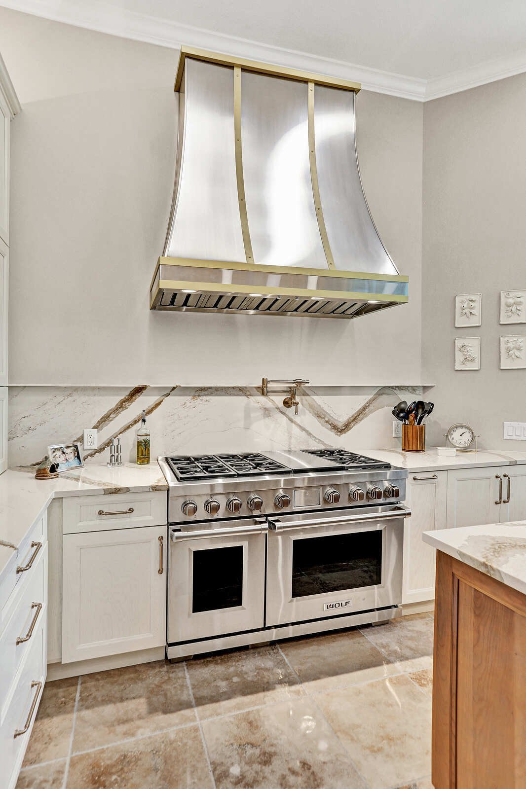 golden contemporary kitchen wolf range gold hood backsplash