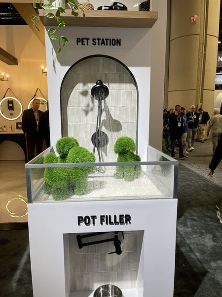 Pet washing station with arched tile, black shower fixture, and topiary pets.