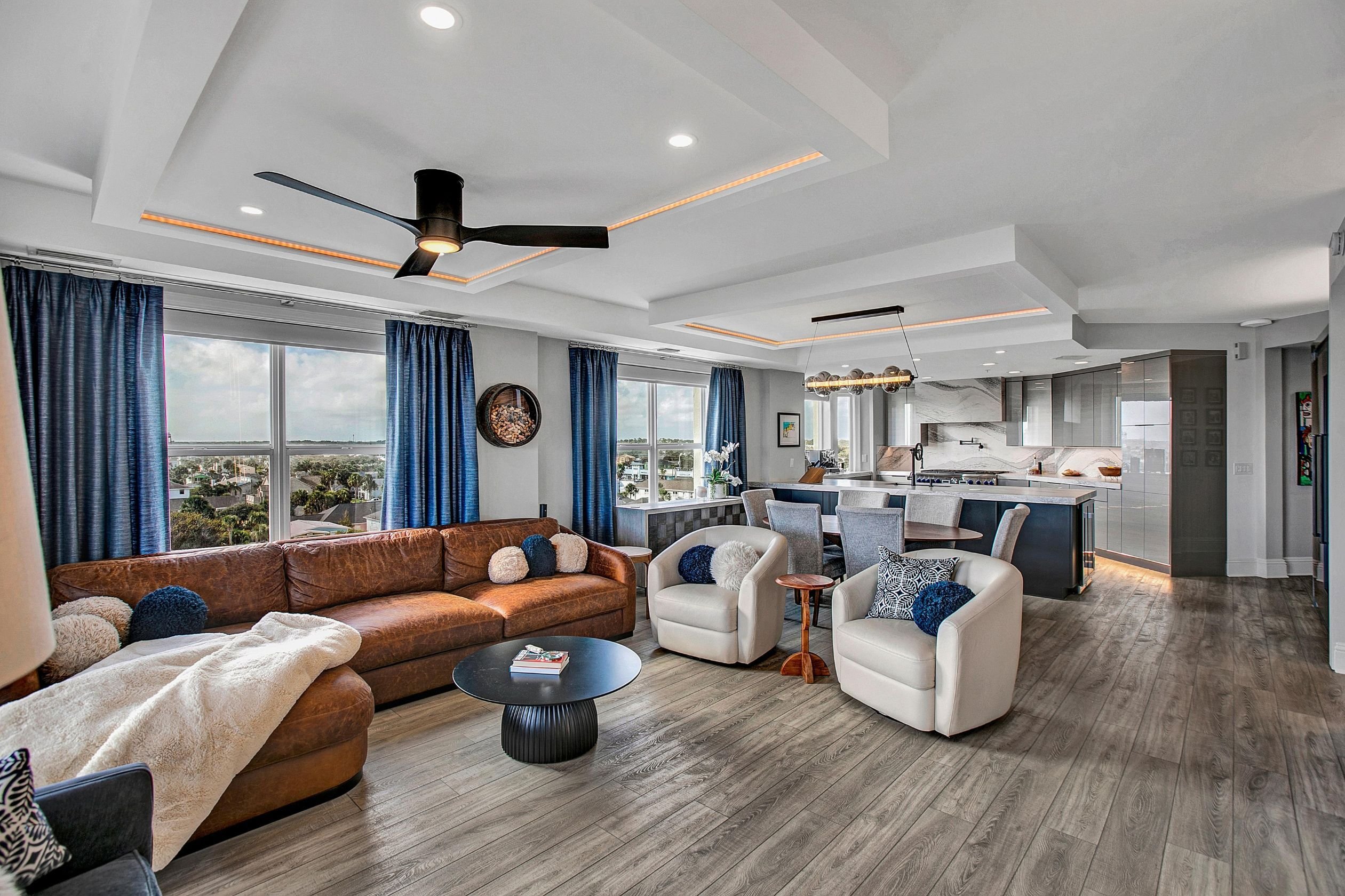 blue and gray kitchen and living area with tray ceiling in jax beach, fl