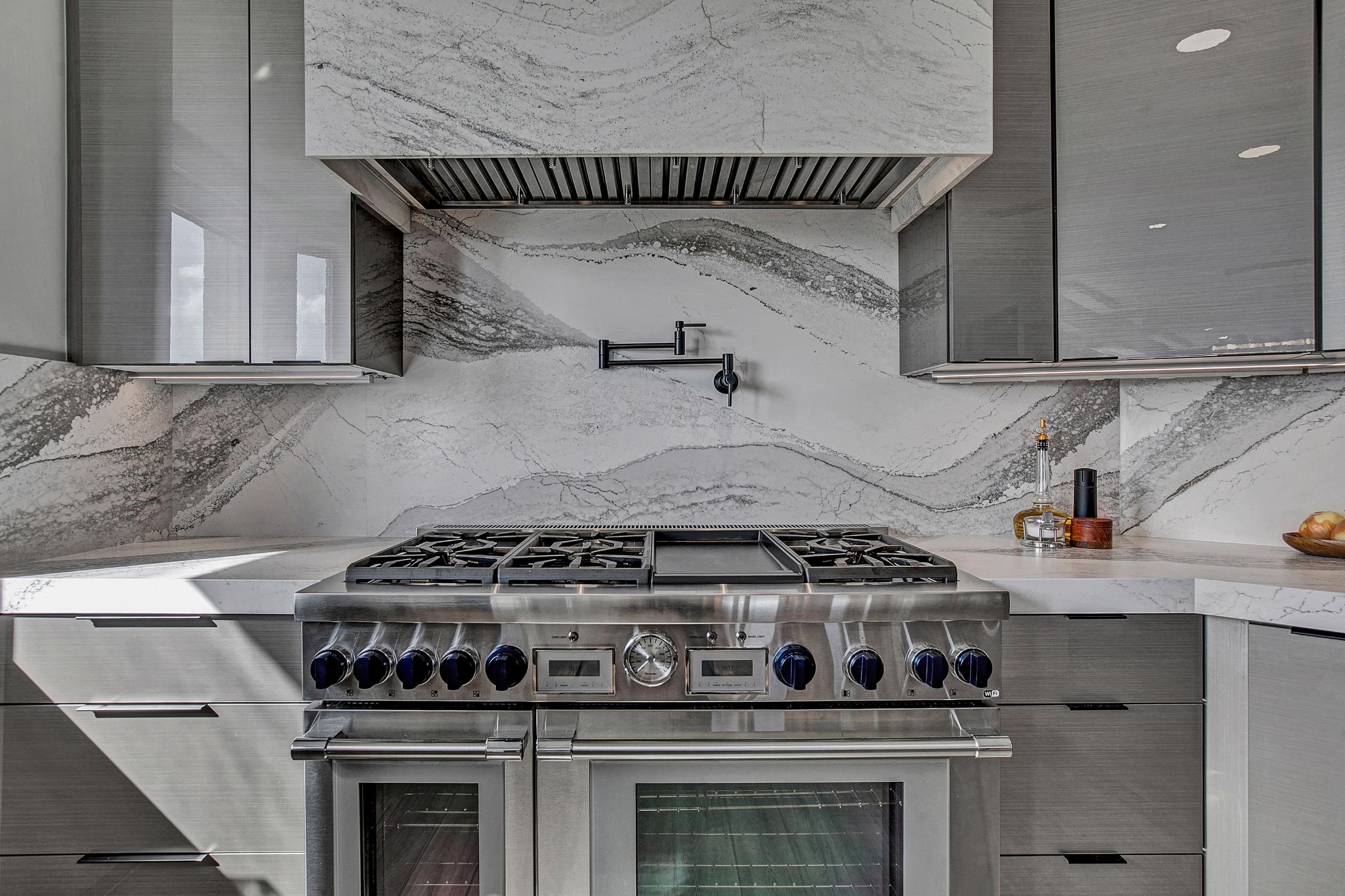 luxury kitchen renovation in jax beach with marble vent hood
