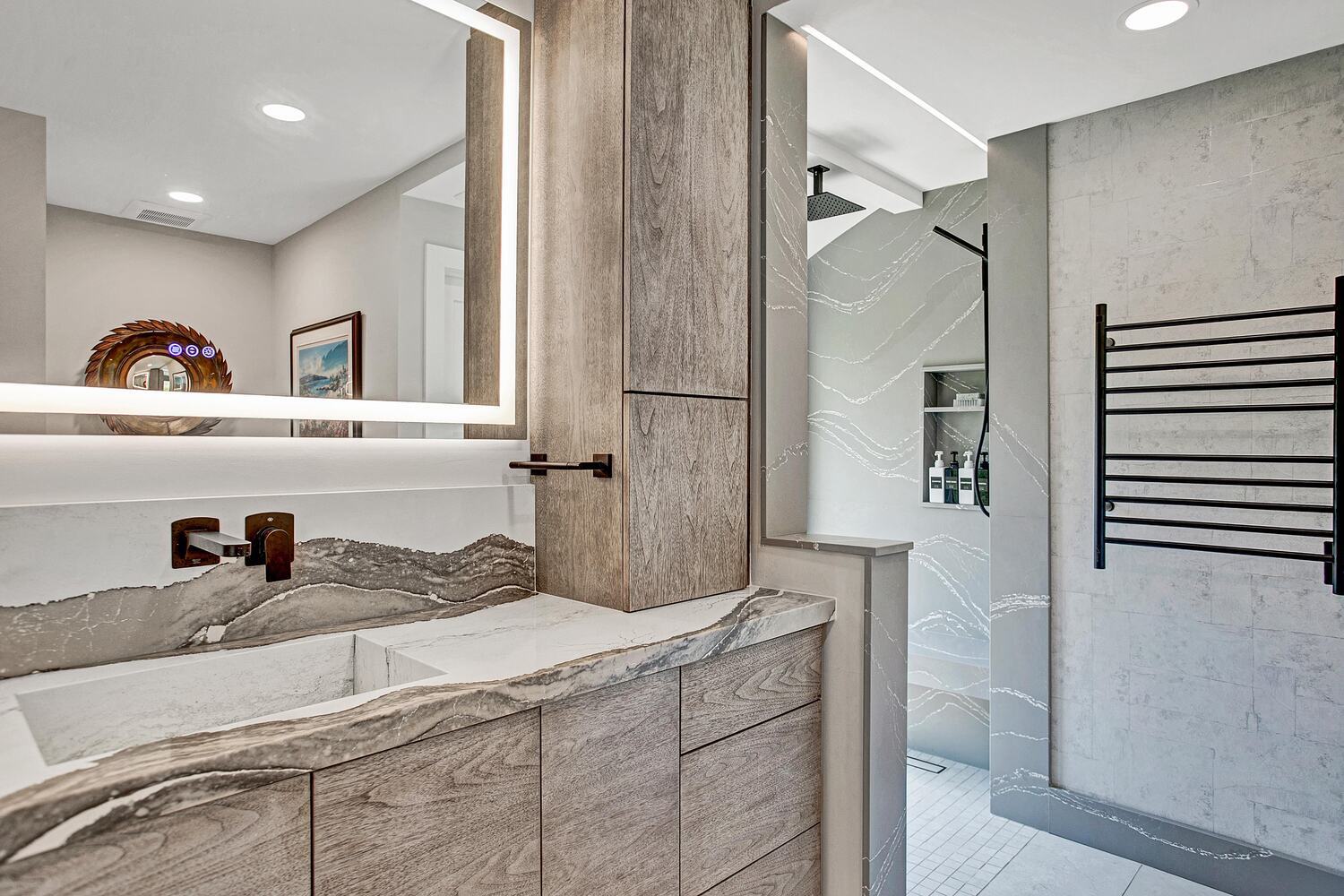 luxury bathroom with textured tile shower and quartz vanity by BeeTree Homes in Jacksonville Beach FL